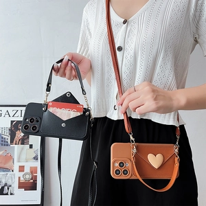 Crossbody iPhone case featuring envelope wallet with heart buckle and detachable strap