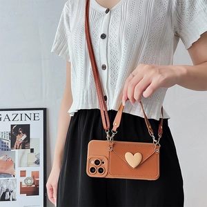 Brown leather crossbody phone case with heart envelope flap and adjustable strap