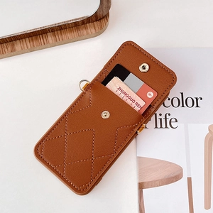 Close-up of brown quilted leather phone case with card slot and metal snap button