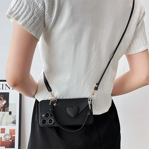 Black crossbody phone case with heart wallet and detachable long strap shown on model