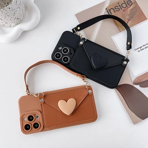 Black and brown leather iPhone cases featuring envelope wallet cards and heart charms
