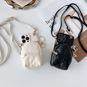 Crossbody iPhone case set featuring mini quilted backpack pouches in black and cream leather