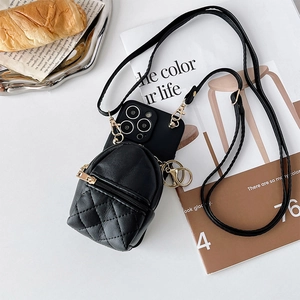 Detail of black quilted mini purse and crossbody leather strap for smartphone case