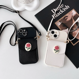 Detail of crossbody phone case featuring a 3D rose wallet and adjustable strap