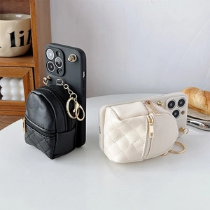 Close-up of quilted leather phone cases with small backpacks and gold zipper details