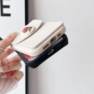 Detail of leather wallet phone case with 3D rose decor and precise port cutouts