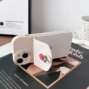 Detail of white iPhone case featuring a 3D red rose wallet and magnetic card holder stand
