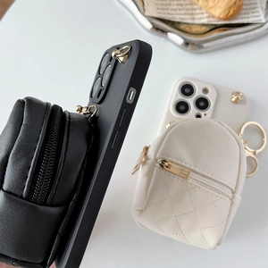 Detail of leather crossbody phone case with quilted zipper mini backpack pouch attachments