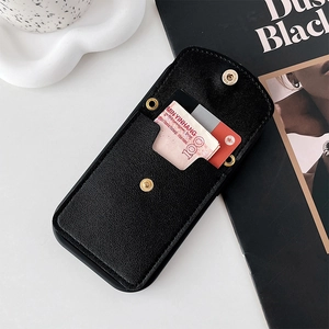 Detail of black lychee leather phone wallet showing card slots and snap closure