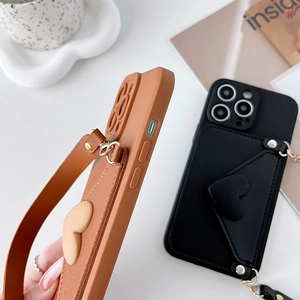 Detail of crossbody iPhone case featuring leather heart card slot and detachable strap