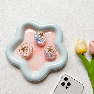 Three-piece starfish phone grip set with glitter sequins in ocean-themed ceramic tray