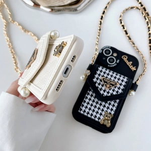 Detail of iPhone case with lychee leather, houndstooth pattern, bear charm and pearl strap