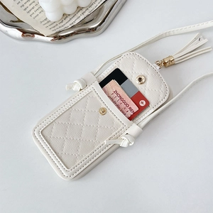 Close-up of cream quilted cross-body phone case with card slot and elegant tassel detail