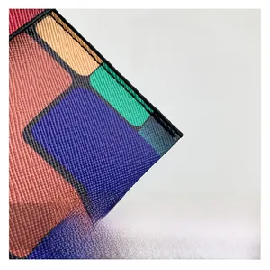 Macro view of Saffiano leather texture and multicolor stitching on envelope clutch bag