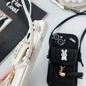 Close-up of quilted leather phone case with mini pouch, rabbit charm and long strap