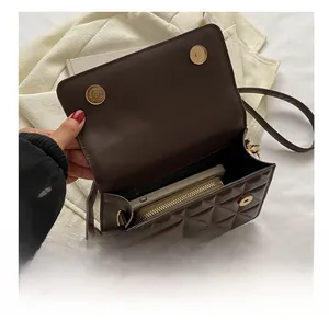 Interior view of the dark brown quilted crossbody bag showing phone and wallet capacity
