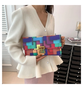 Close-up of colorful geometric patchwork clutch bag with gold double E metal lock