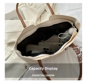 Top view of large cream tote bag showing interior storage for phone, wallet and umbrella
