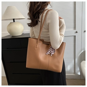 Detail view of brown PU leather tote bag with a checkered ribbon and spacious design