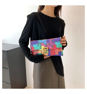 Detail of color-block geometric pattern on faux leather handbag with gold metal lock