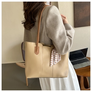 Detail of soft PU leather tote bag with elegant checkered ribbon and shoulder strap
