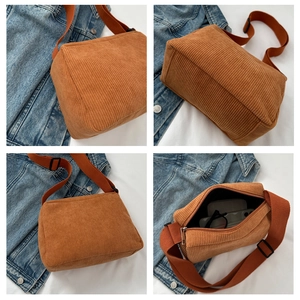 Macro detail of caramel corduroy tote bag showing soft texture and zipper closure