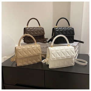 Close-up of diamond quilted crossbody bags with woven handles in four classic colors