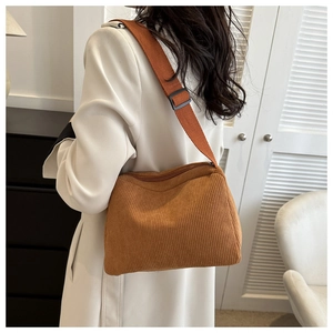Detail of adjustable strap and corduroy texture on the brown crossbody tote bag