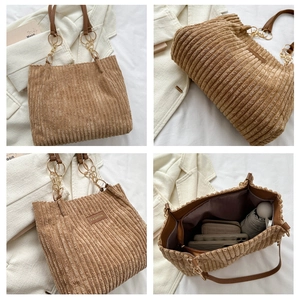 Detail of brown corduroy tote bag showing large capacity for umbrella and wallet