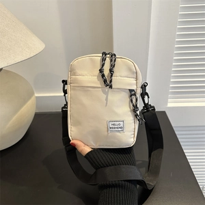 Minimalist beige nylon crossbody bag with Hello Weekend label and adjustable black strap