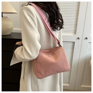 Detail of pink corduroy tote bag showing ribbed texture and wide shoulder strap