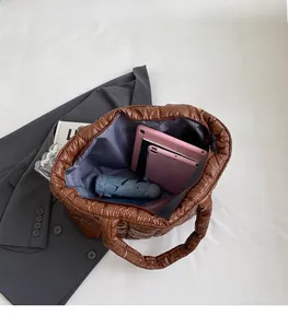 Interior view of large brown quilted tote bag showing space for tablet and umbrella