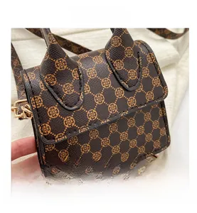 Detailed view of mini PU leather crossbody bag with vintage monogram and gold buckle