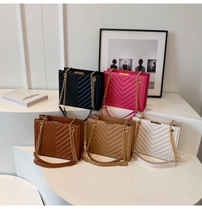 Detail of five crossbody bags featuring chevron stitching and gold chain straps