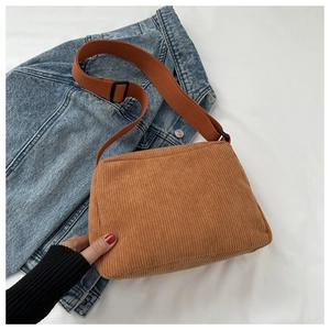 Detail of caramel corduroy tote bag showing soft ribbed texture and adjustable strap