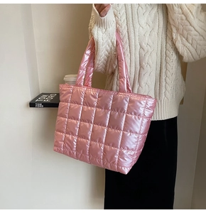 Detailed view of pink metallic quilted tote bag with padded texture and glossy finish