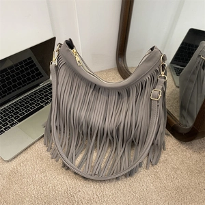 Bohemian style grey tassel bucket bag with gold zipper and adjustable shoulder strap