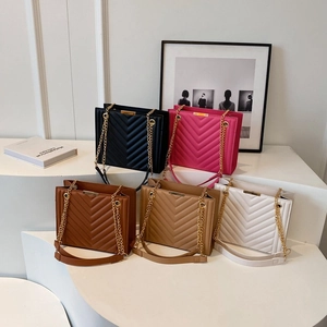 Quilted tote bags with V-stitch patterns and gold chain straps in five colors