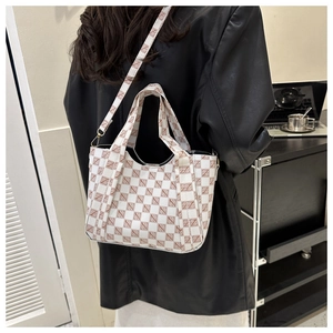 Fashionable tote bag with vintage geometric print worn over the shoulder in a lifestyle setting