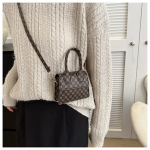 Detail view of mini PU leather square crossbody bag with vintage geometric gold dot patterns