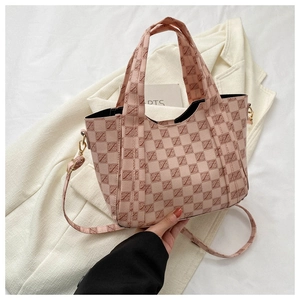 Detailed close-up of pink retro printed tote with golden hardware and adjustable strap