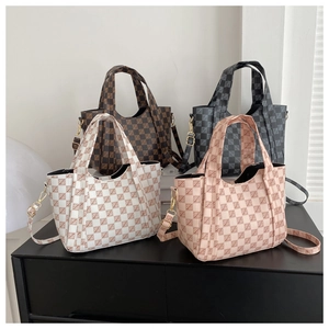 Detail of checkered tote bags in four colors with leather handles and gold metal hardware