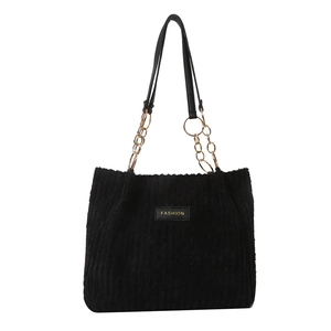 Large black corduroy tote bag with metal chain straps and fashion label for women