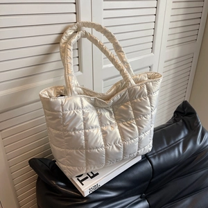 Glossy off-white quilted tote bag with padded texture for autumn winter fashion styles
