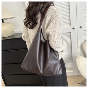 Model wearing dark brown soft leather tote bag with large capacity for autumn/winter