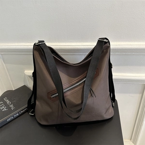 Coffee brown large capacity tote bag with adjustable strap and front zipper detail