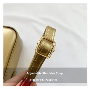 Close-up of adjustable golden synthetic leather shoulder strap with metal buckle detail