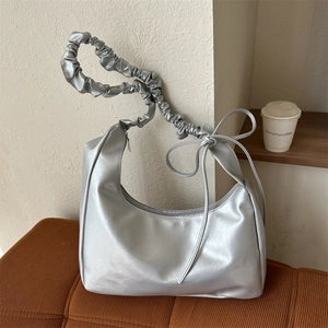 Silver pleated cloud shoulder bag with chic bow handle for women in trendy urban style