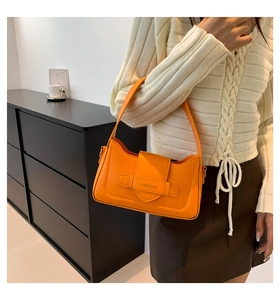 Detail of the orange leather shoulder bag featuring a stylish buckle and Jiashiqing text