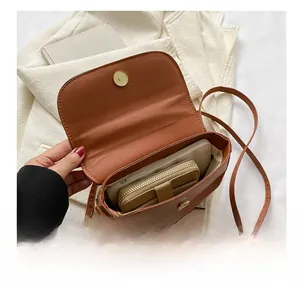 Interior view of the brown leather crossbody bag showing space for phone and wallet